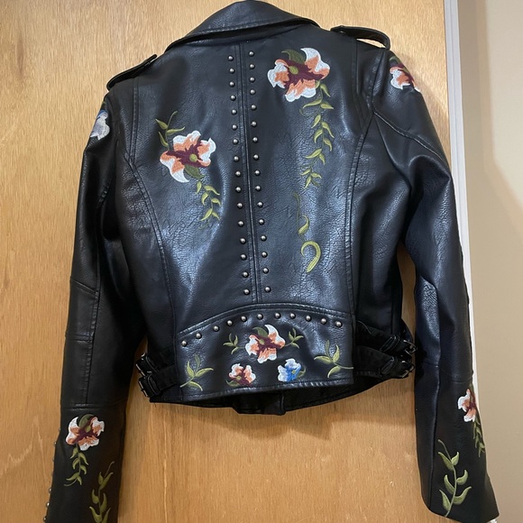 Floral embroidery, stud accents, buckles on side, faux leather, zipper on arms. - Picture 3 of 8